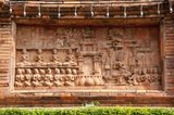 This stone relief at the Chamathewi statue shows the repopulation of Lamphun in the 19th century.<br/><br/>


Lamphun was the capital of the small but culturally rich Mon Kingdom of Haripunchai from about 750 AD to the time of its conquest by King Mangrai (the founder of Chiang Mai) in 1281.<br/><br/>

Lamphun became famous after the enthronement of Queen Chama Thewi (Chamadevi), probably during the late 9th or early 10th century AD. The Lan Na chronicles, verified where possible by archaeology and other corroborative texts, suggest that the foundations of the Kingdom of Haripunchai were laid at Lamphun by a group of Buddhist monks from Lopburi some time in the 8th or 9th century AD. These monks asked the Mon king of Lopburi to provide them with a ruler for their city, and he sent his daughter, Chama Thewi, who arrived in Lamphun accompanied by a large retinue of Mon retainers.<br/><br/>

The new queen was a woman of strong character, who tenaciously defended the interests of Haripunchai against the local Lawa people, and actively promoted Buddhism in the region. She founded a dynasty that was to last until the mid-11th century, and established her capital, Lamphun, as an important centre of Mon culture and influence. 